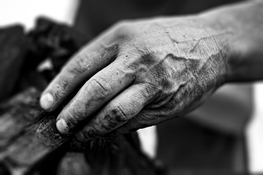 black and white photo of someone's hand and knuckles