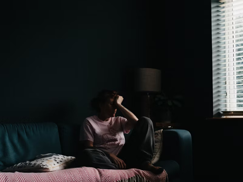 a person sitting in a dark room alone