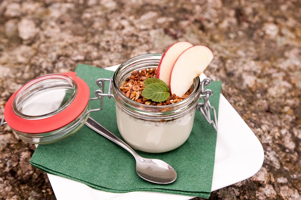 A vibrant display of apple and cinnamon granola, highlighting its crunchy texture and the warm hues of cinnamon and apple.