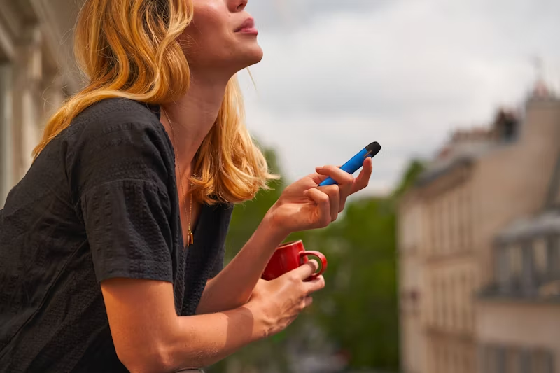 a woman vaping outside