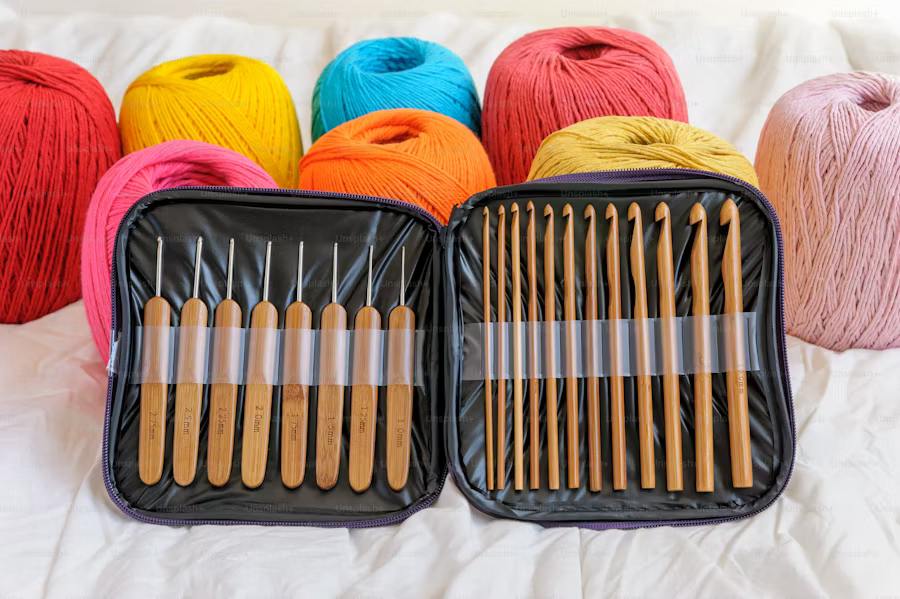 A decluttered bag containing colorful yarn and knitting needles neatly arranged in a protective case.