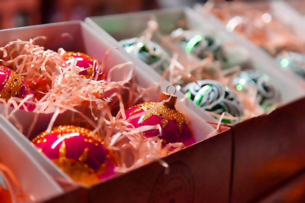 Decluttered Christmas ornaments neatly arranged in colorful boxes, ready for holiday decoration and festive celebrations.