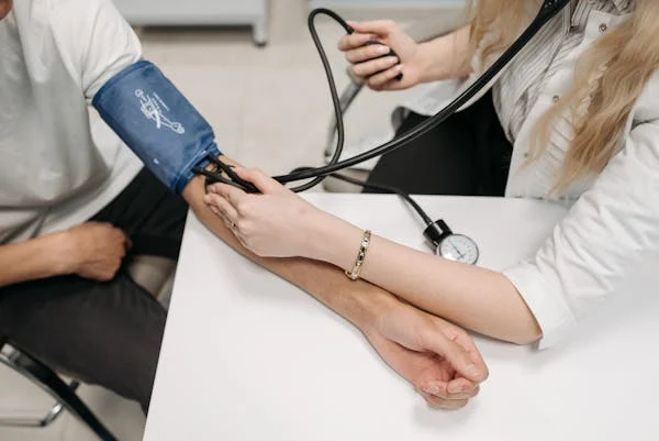 nurse taking patients blood pressure