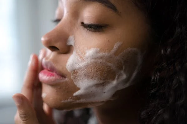 Woman washing her face with soap