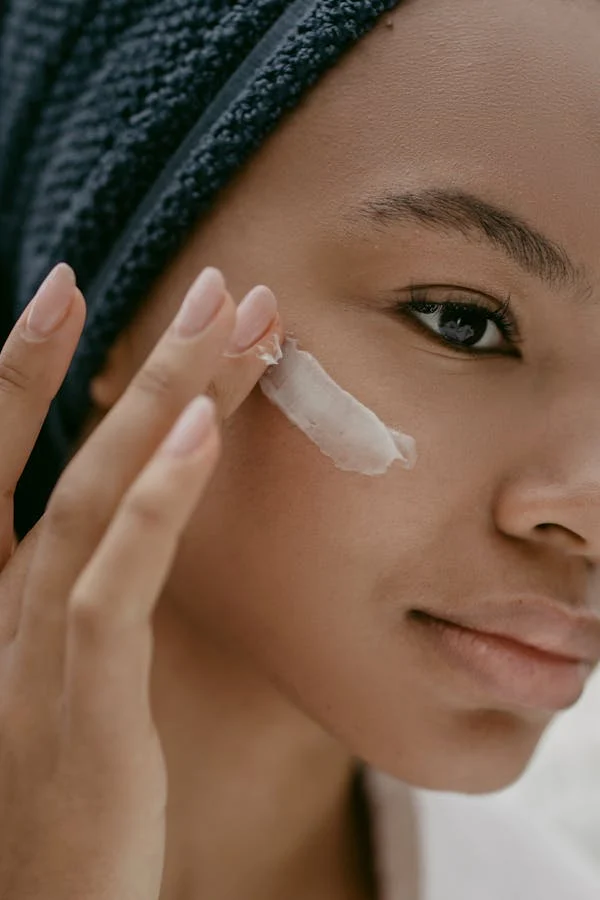 woman applying sunscreen to her face with her fingers