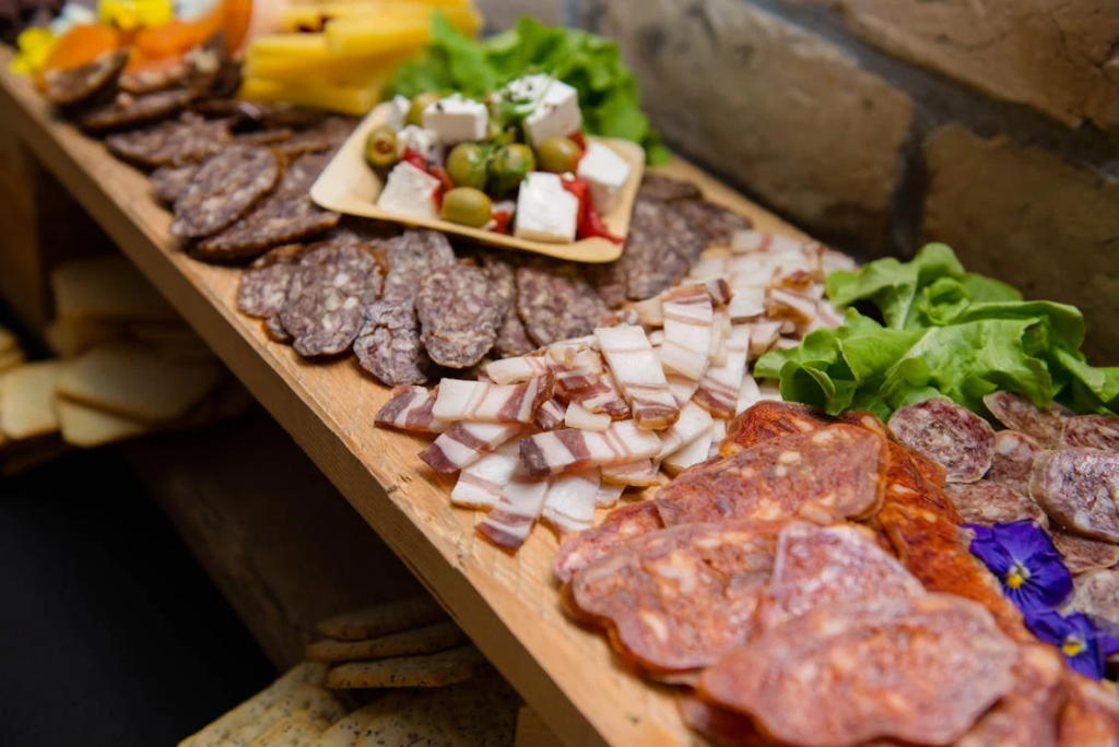 Various choice of meat sausages and pork fat on sideboard