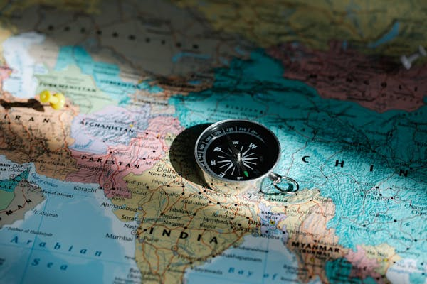 Map of the world with a compass set on it