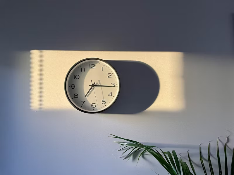 the sun setting on a clock showing 7:16