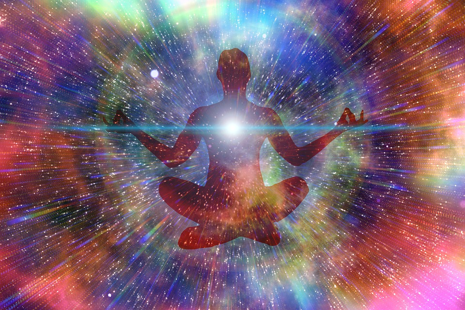 A man meditates peacefully, surrounded by a vibrant nebula, symbolizing the connection between the soul and the universe.