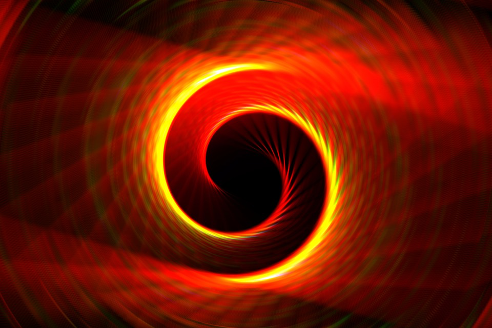 A vibrant red and yellow spiral contrasts against a dark background, symbolizing the essence beyond the physical body.