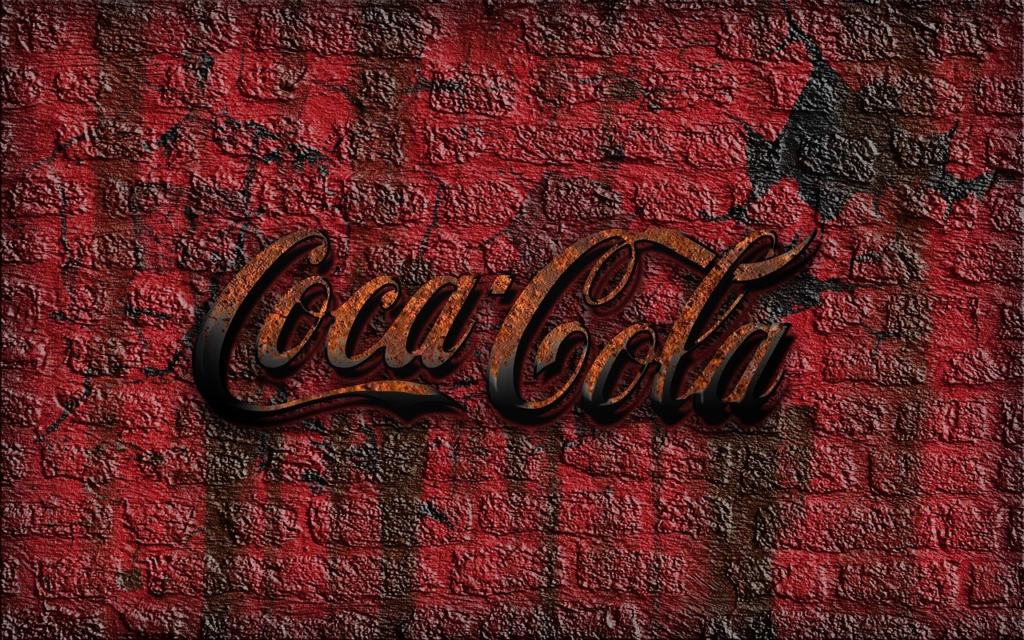a worn out Coca-Cola logo on a red wall