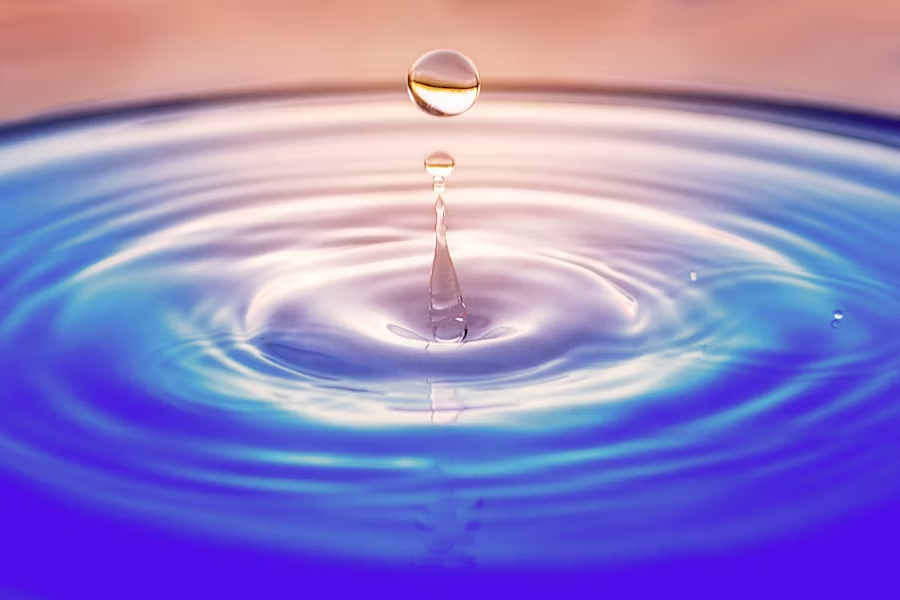 a water droplet on a pool of water