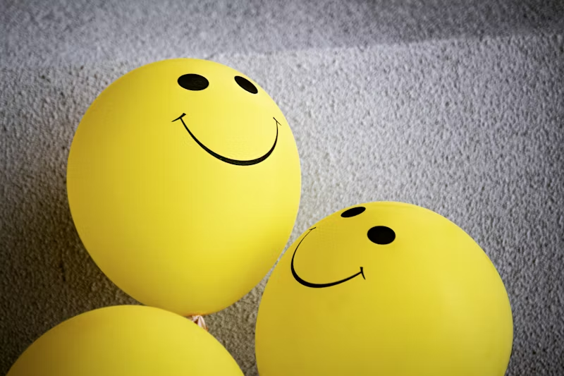 yellow happy-faced balloons