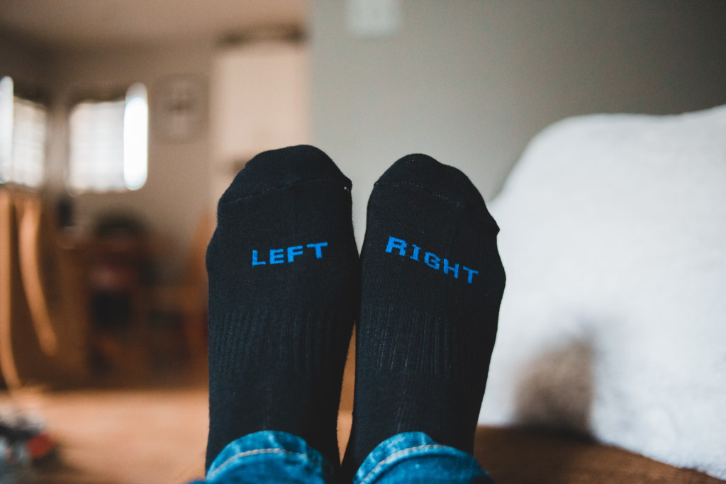 A pair of left and right socks, highlighting the temperature difference often felt in feet due to circulation issues.
