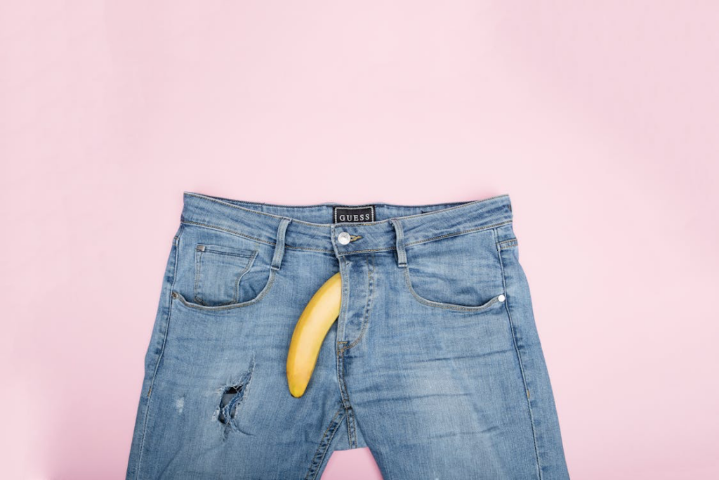 A pair of jeans with a banana peeking out of the pocket, erectile dysfunction symbolizing erectile dysfunction.