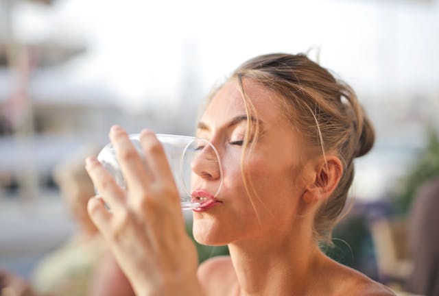 woman drinking glass of water