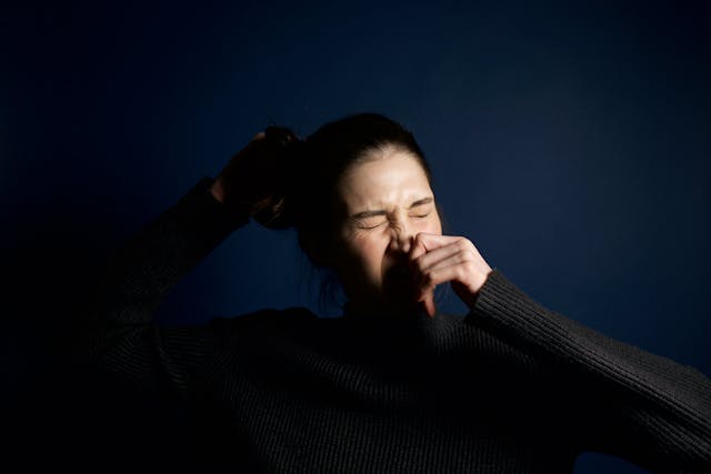 woman sneezing