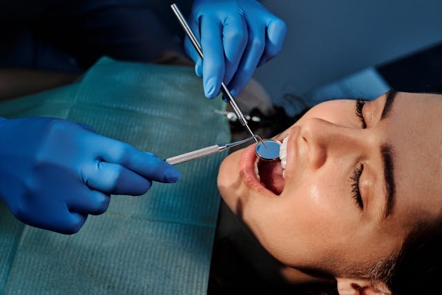 dentists looking at teeth of pateint