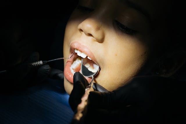 dentist looking into mouth of patient