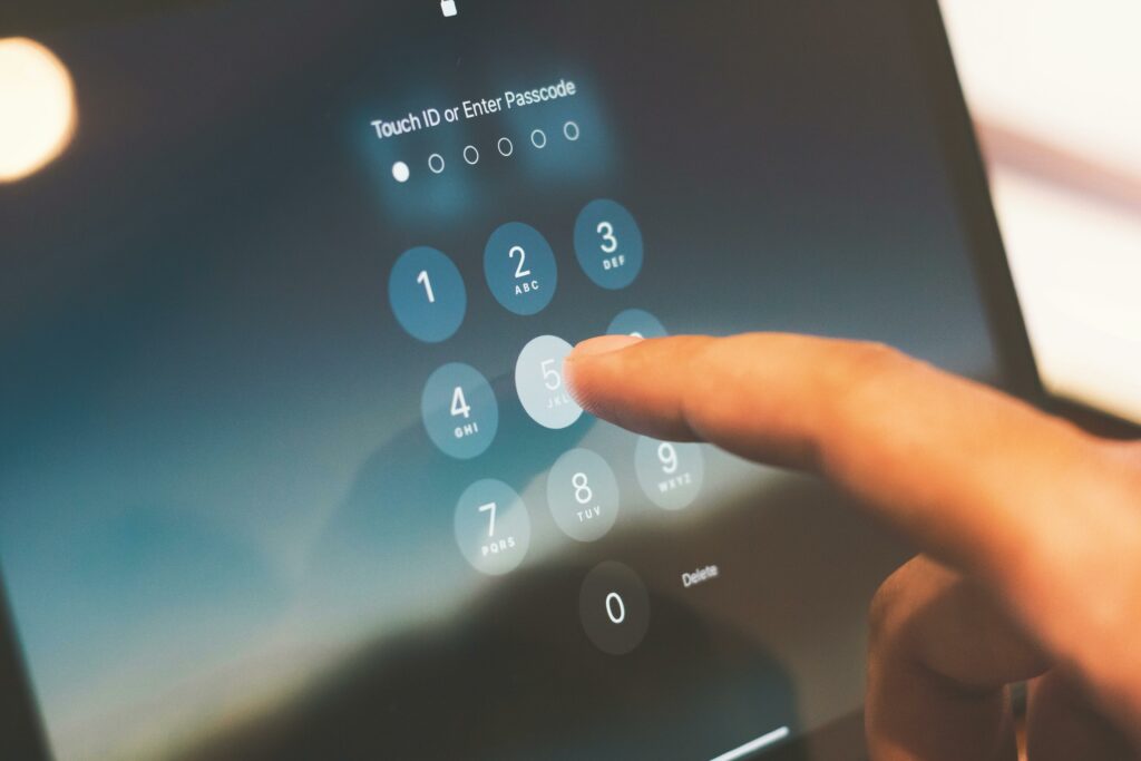 Persons hand entering PIN number on touchscreen