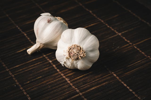 two garlic bulbs on a table top
