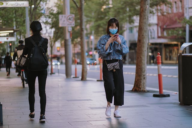 people walking on the street with masks