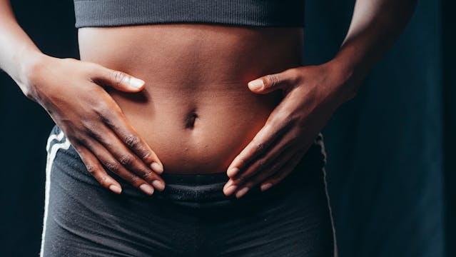 woman holding her abdomen