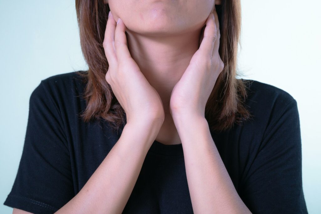 woman holding her throat