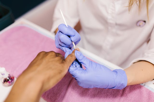 woman working on a fingernail