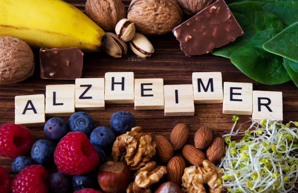 "Alzheimer" word written on wooden blocks and foods supporting the treatment of Alzheimer's Disease