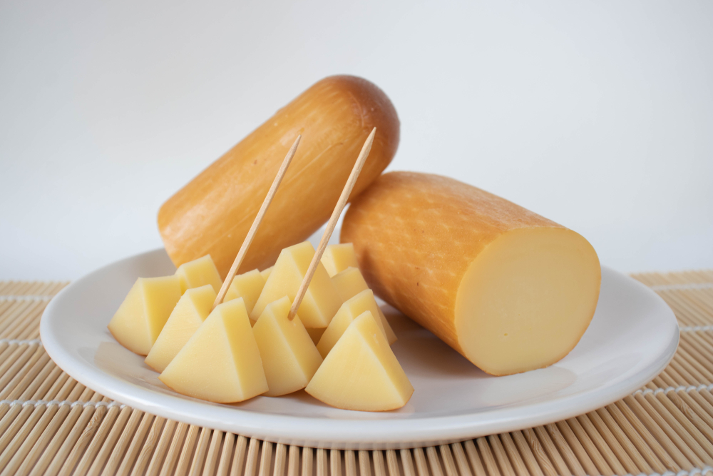 Provolone cheese on a plate on a white background