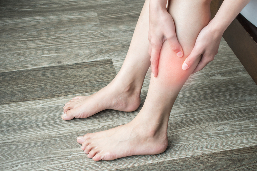 Closeup of woman hands holding and massaging her calf, suffering from calf pain. Calf pain may be muscle-related diagnoses, there are some potentially serious ones , like a blood clot or claudication.
