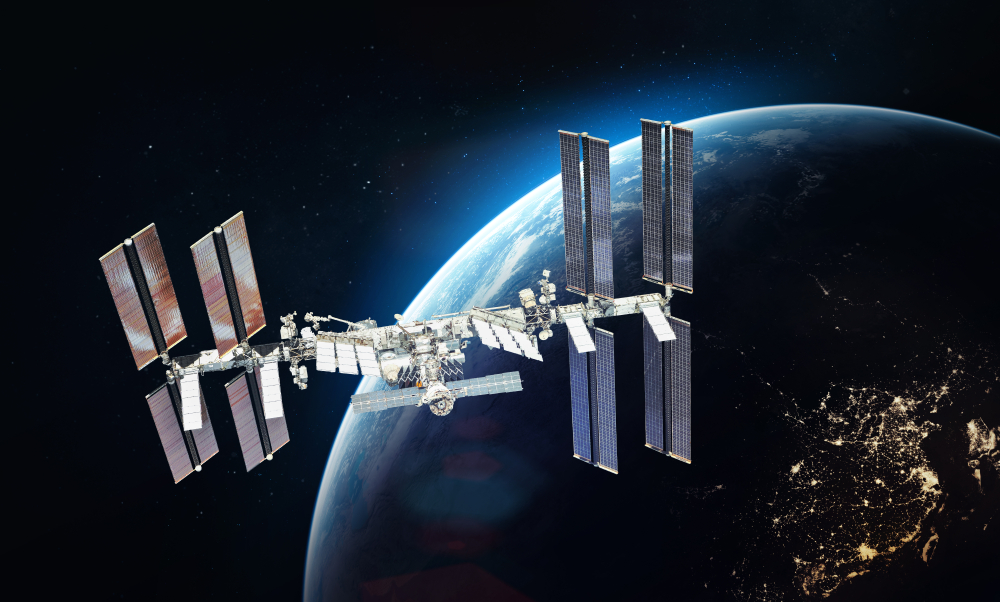 ISS station on orbit of the Earth planet. Nightly lights from the cities. Dark background. Elements of this image furnished by NASA
