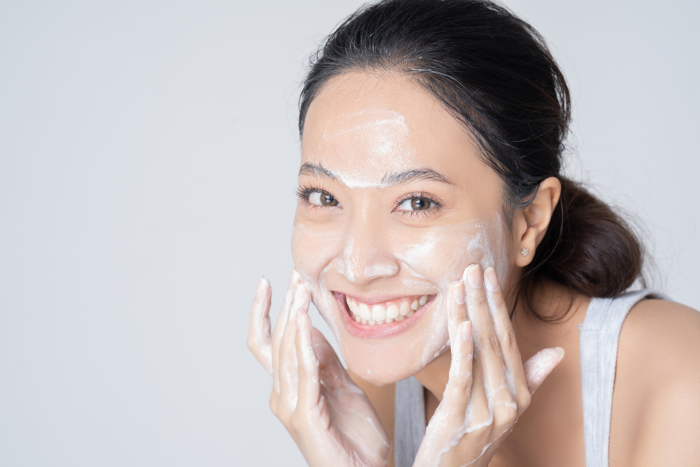 Beautiful female asian Wash face in studio

