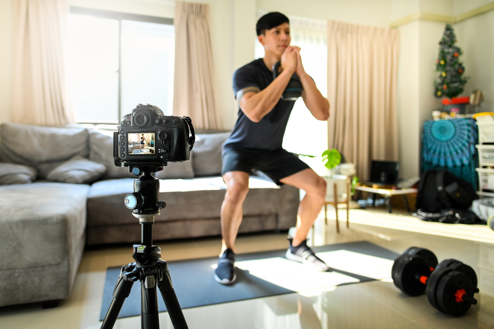 Teenage boy looks at muscle of his arm in mirror, concerned about his musculature and physique, muscle-building obsession, body dysmorphism disorder, masculinity and muscularity
