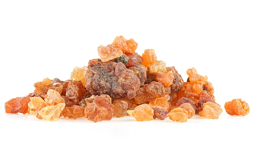 Pile of natural Commiphora myrrha isolated on a white background. Frankincense Olibanum. Myrrh resin. Incense.
