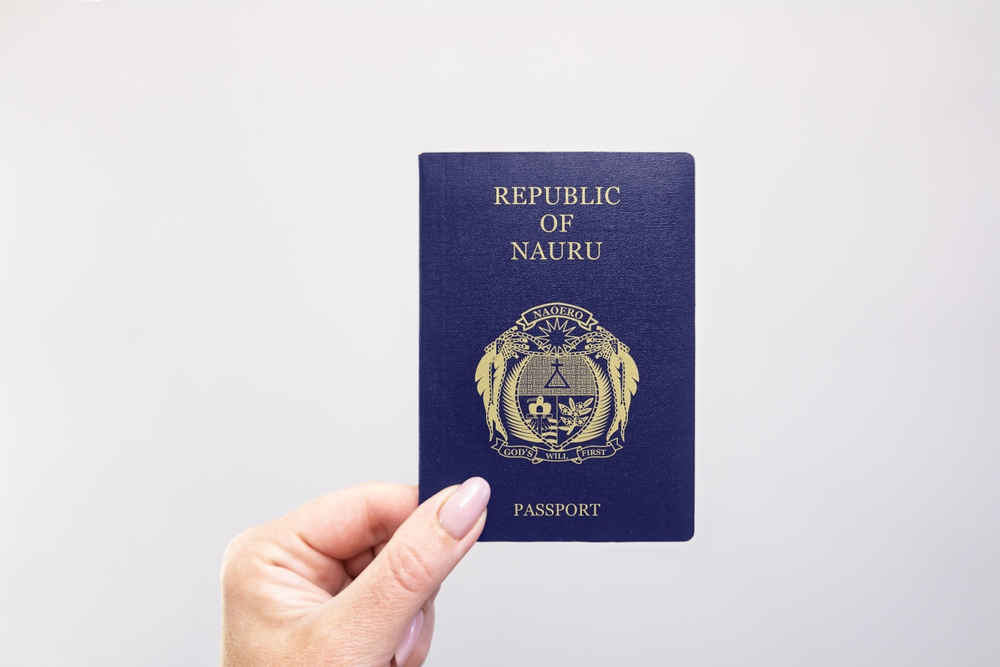 Close-up of a Nauru passport held in hand against a plain white background. Astana, Kazakhstan, 26 october 2024
