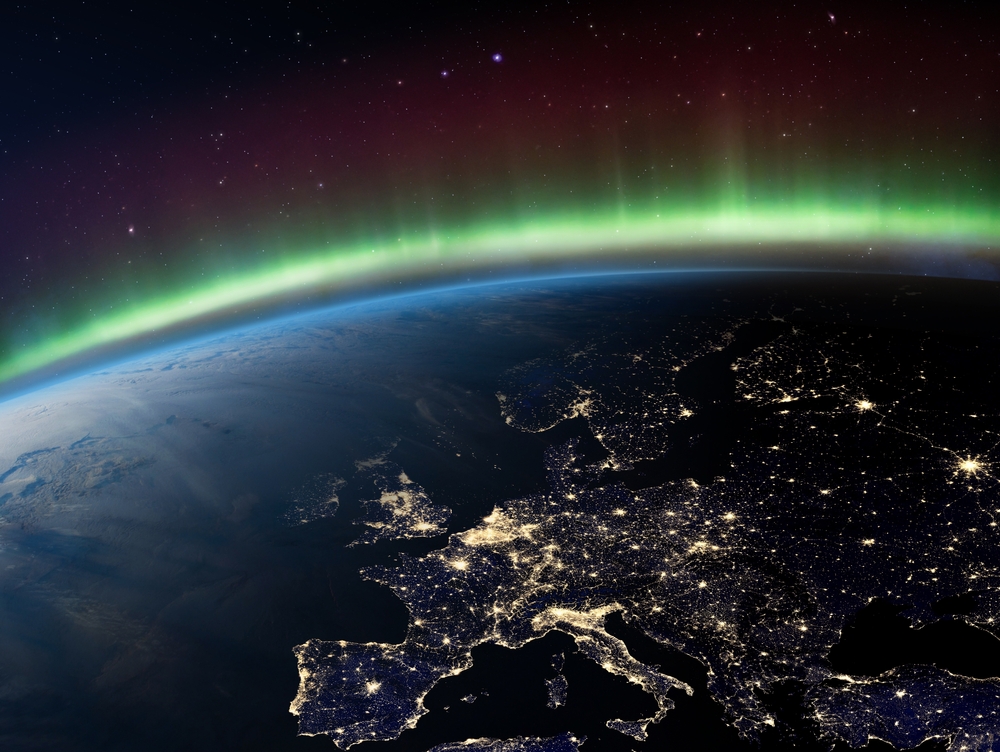 Planet Earth from the space at night and Northern Lights or Aurora Borealis related to the Earth's magnetic field. Europe at night viewed from space. Elements of this image furnished by NASA.