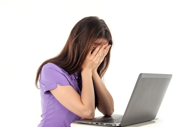 woman suffering from psychiatric disorder working from her desk.