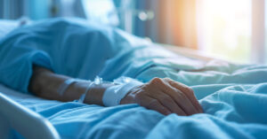 person in hospital gown laying in bed
