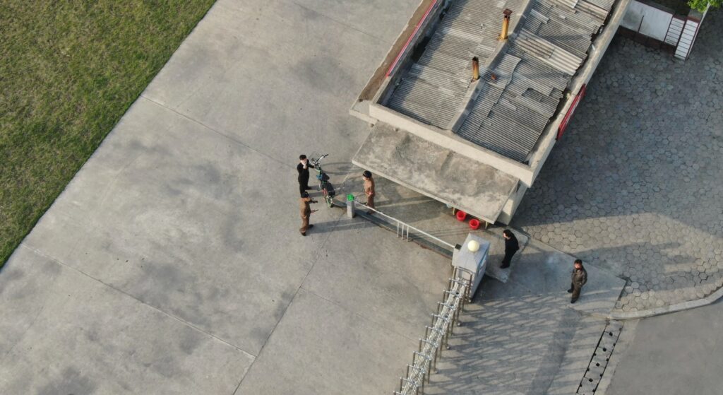 North Korea residents pointing up at drone