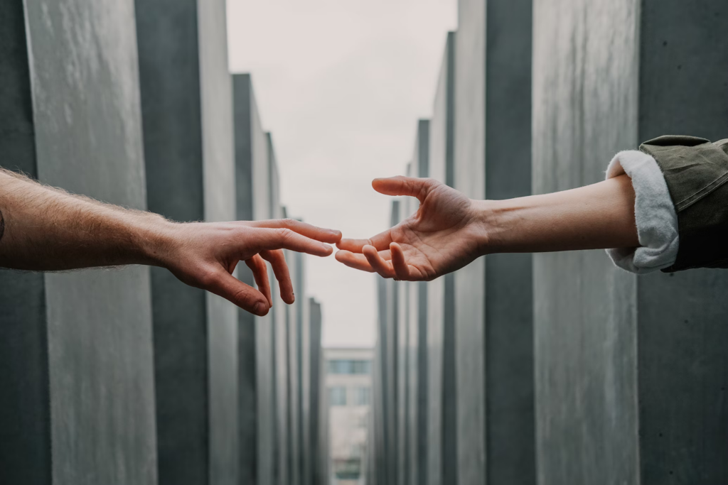 Two people reaching out to each other, symbolizing connection and the importance of sexual health for mental well-being.