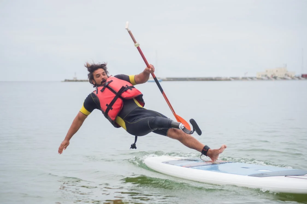 Man Falling into Water from Paddleboard