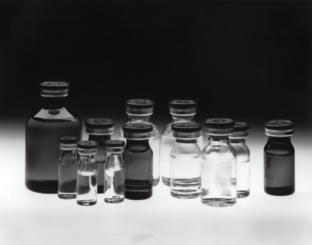 A black and white image featuring multiple bottles, representing various chemotherapy medications.