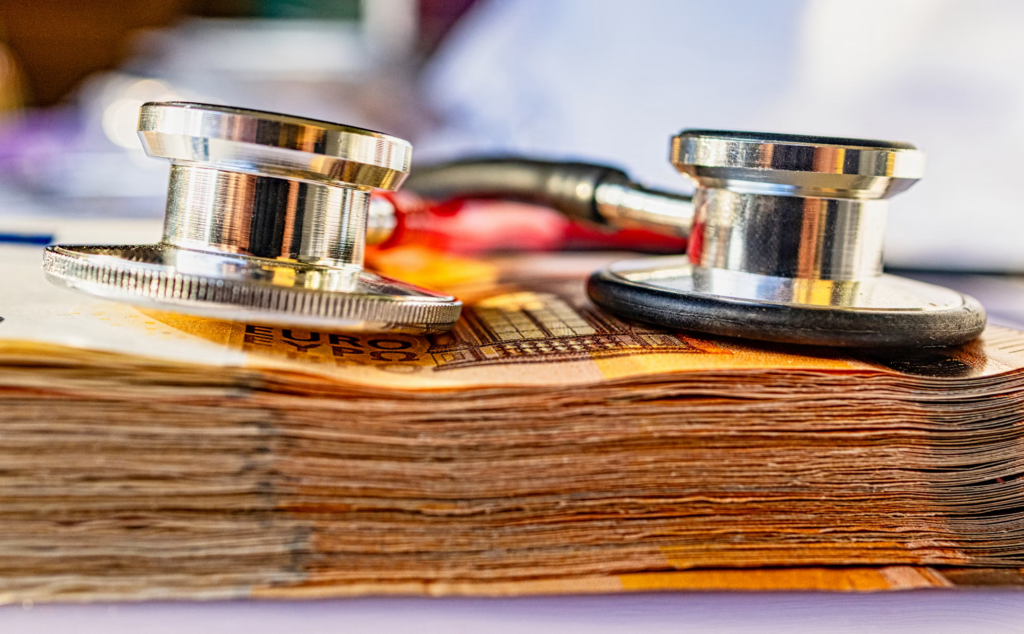 A stethoscope rests on a stack of money, symbolizing financial health and the importance of seeking credit counseling.