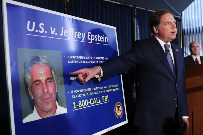 US Attorney Geoffrey Berman points to a photograph of Jeffrey Epstein