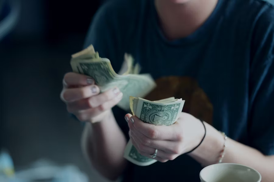 hands counting American dollars