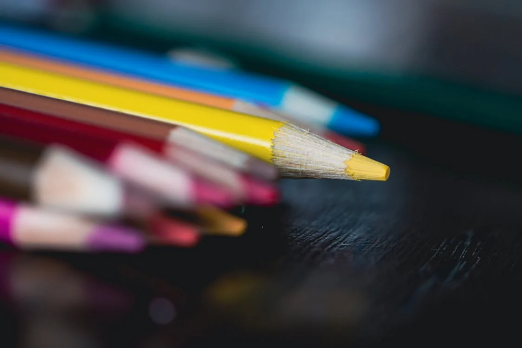 A collection of colorful pencils on a black table