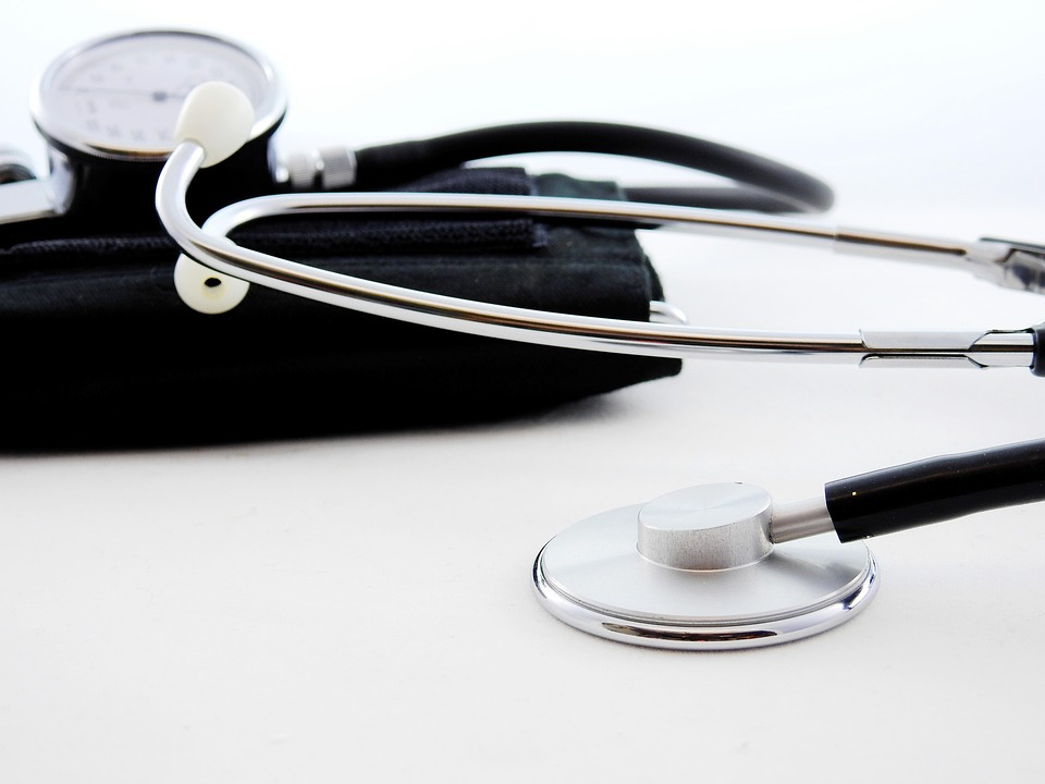 A stethoscope and blood pressure cuff resting on a white surface, reminding us to listen to our bodies and seek help when needed.
