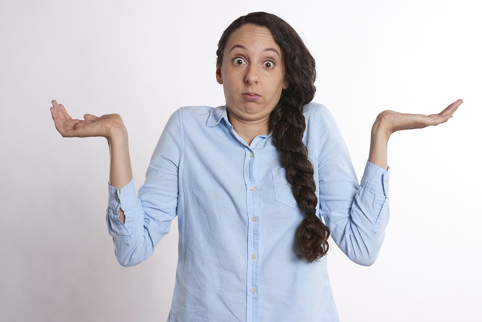 A woman with a puzzled or confused expression, shrugging her shoulders and raising her hands in a gesture that suggests she is struggling to understand something. This visual can be associated with the cognitive challenges many people face due to sleep apnea symptoms. 